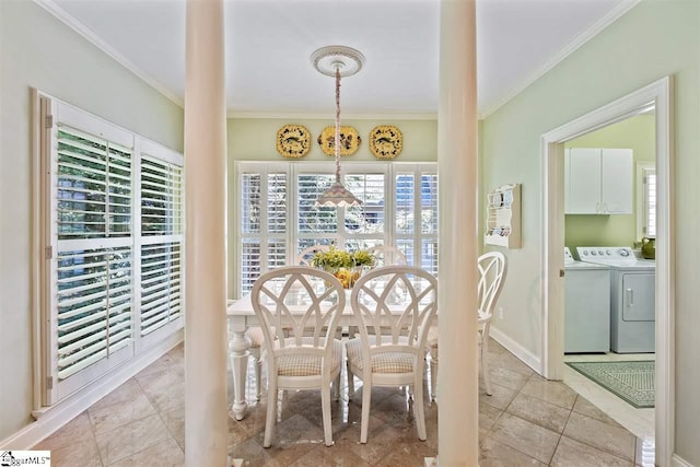 dining room featuring crown molding, washer and dryer, and light tile floors