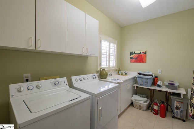 laundry room with sink, cabinets, light tile flooring, and washer and clothes dryer