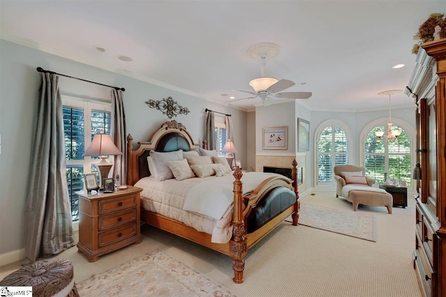 bedroom with crown molding, ceiling fan with notable chandelier, and light carpet