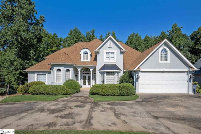 view of front of home with french doors and a garage