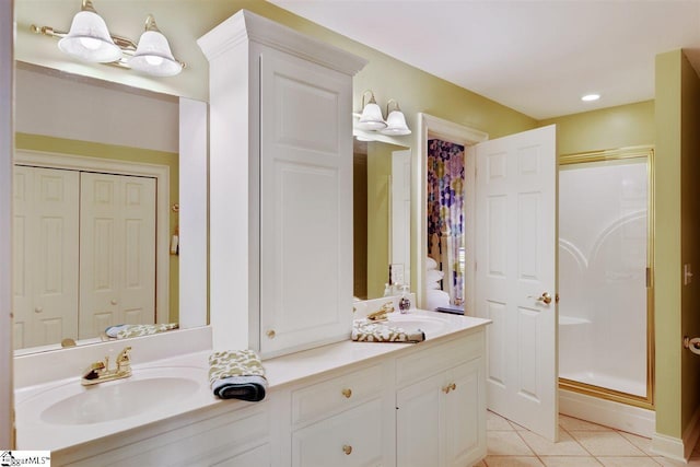 bathroom with walk in shower, tile floors, and vanity with extensive cabinet space