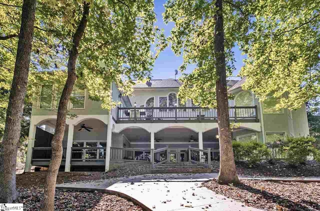 rear view of property with ceiling fan