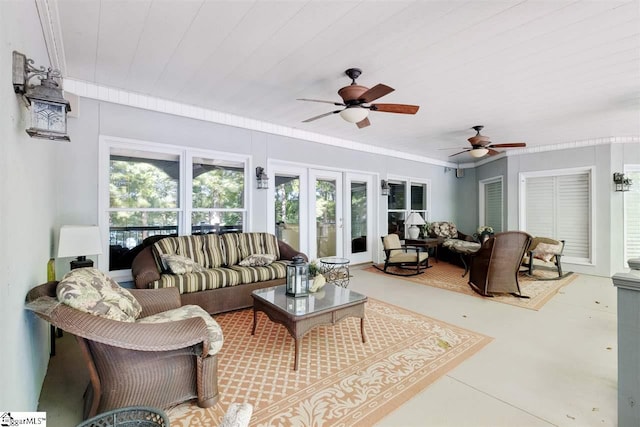 living room with ornamental molding, ceiling fan, and french doors