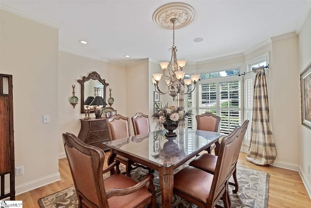 dining room featuring ornamental molding, a notable chandelier, and light wood-type flooring