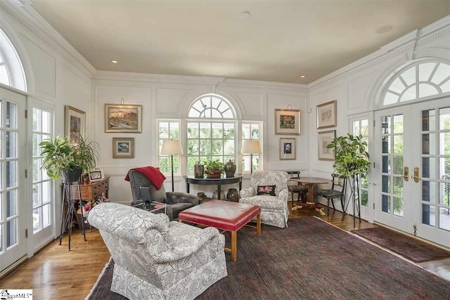 sitting room with ornamental molding, dark hardwood / wood-style floors, and french doors