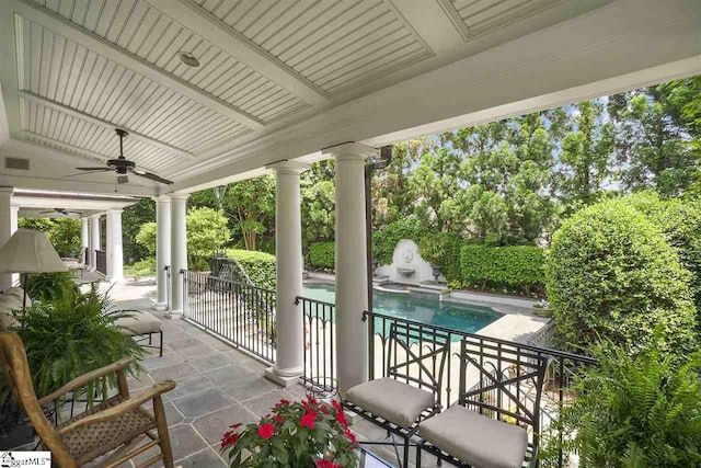 view of patio with a fenced in pool and ceiling fan