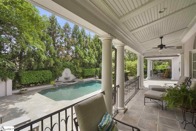 view of swimming pool featuring ceiling fan and a patio area