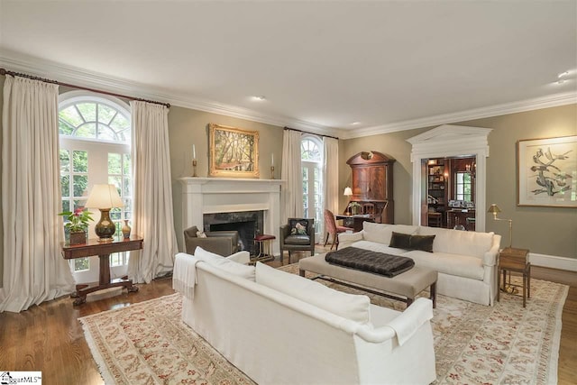 living room featuring plenty of natural light, wood-type flooring, and crown molding