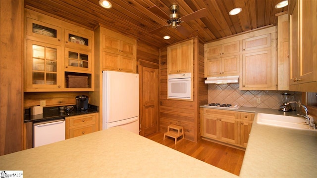 kitchen featuring wood-type flooring, ceiling fan, white appliances, sink, and wood ceiling