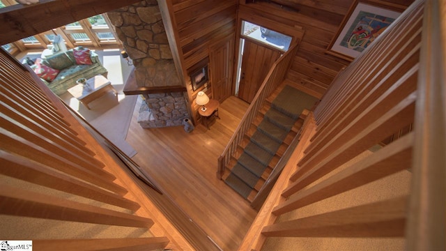 stairs with light hardwood / wood-style flooring and a high ceiling