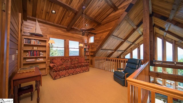 living room with lofted ceiling with beams, carpet floors, and ceiling fan