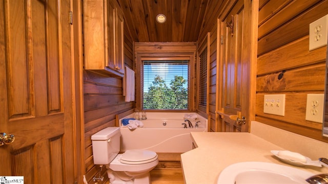 bathroom with a bathing tub, sink, wooden ceiling, toilet, and wooden walls