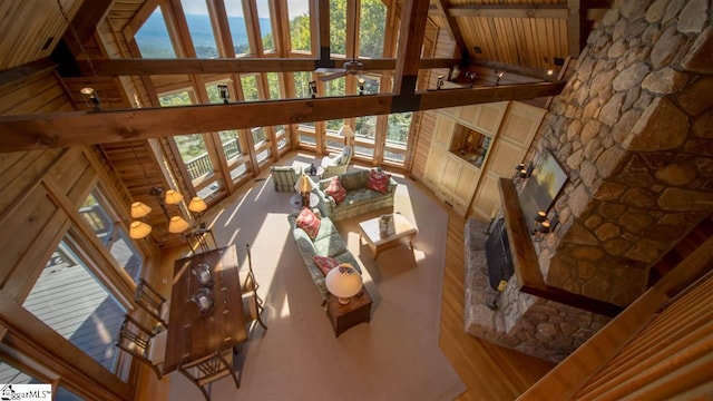 living room featuring high vaulted ceiling, wood-type flooring, ceiling fan, and beamed ceiling