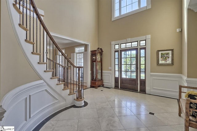 entrance foyer featuring light tile floors and a high ceiling