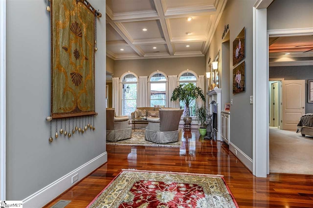 corridor featuring crown molding, beamed ceiling, coffered ceiling, dark wood-type flooring, and a barn door