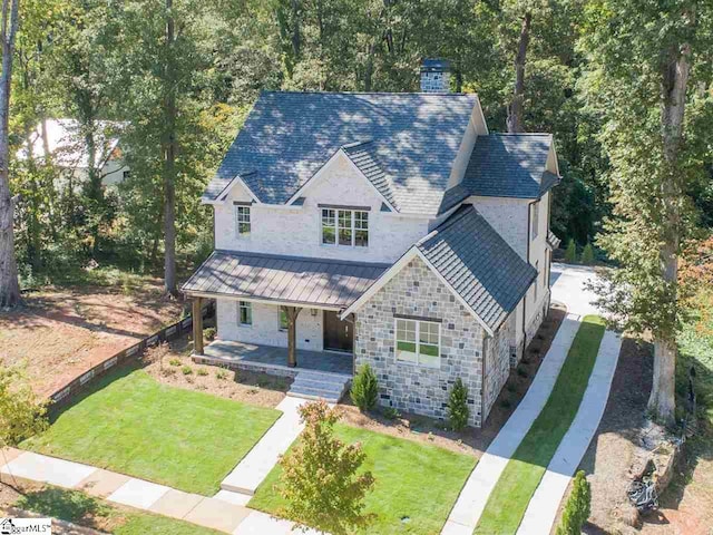 view of front of property with a front lawn and covered porch