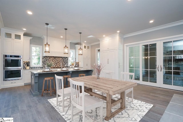 dining room featuring crown molding, french doors, and dark hardwood / wood-style flooring