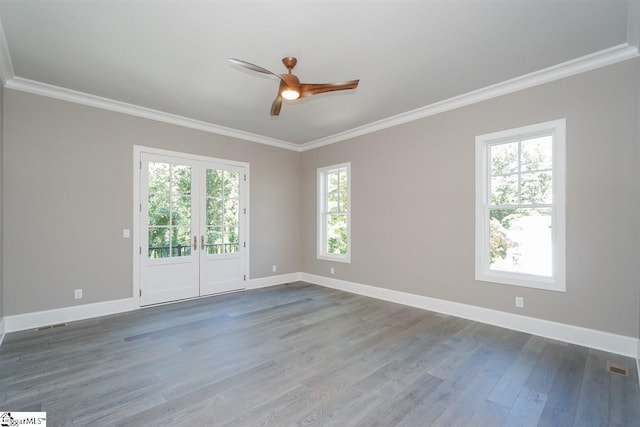 empty room featuring ceiling fan, ornamental molding, and dark hardwood / wood-style flooring