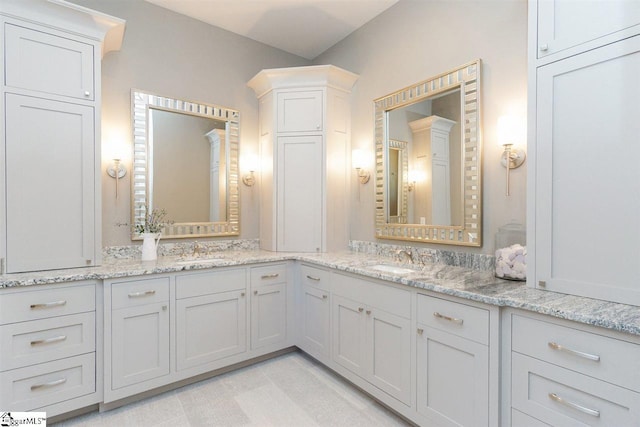 bathroom with dual vanity and tile floors