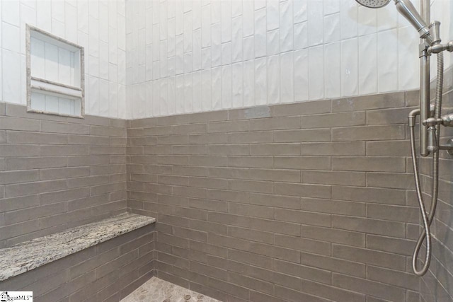 bathroom with a tile shower