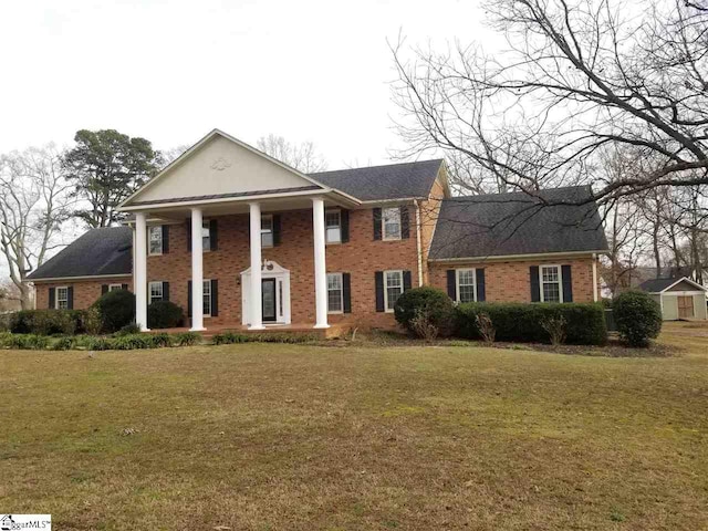 greek revival inspired property with a front yard