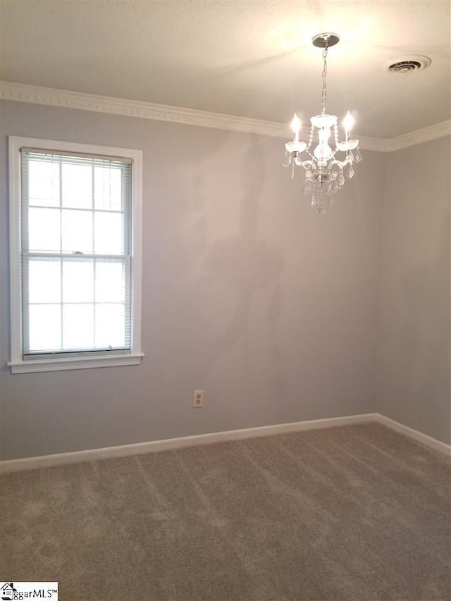 carpeted spare room with an inviting chandelier and ornamental molding