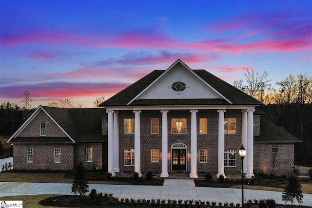 greek revival inspired property featuring a porch