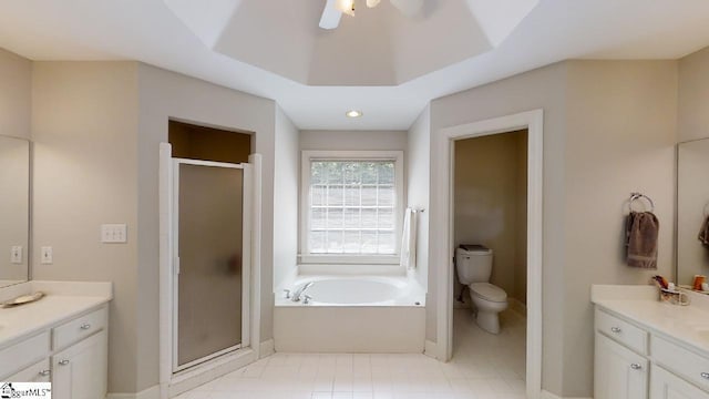 full bathroom featuring toilet, ceiling fan, vanity with extensive cabinet space, separate shower and tub, and tile floors