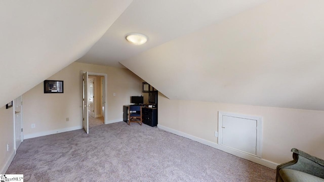 bonus room featuring light colored carpet and vaulted ceiling