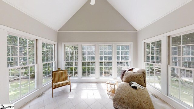 sunroom with ceiling fan and vaulted ceiling