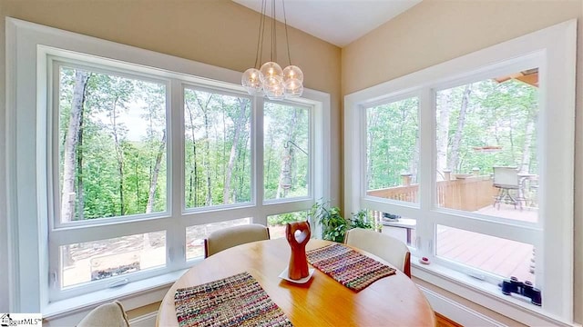 sunroom / solarium featuring a notable chandelier and a wealth of natural light