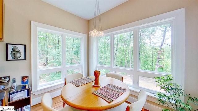 dining space with a chandelier and hardwood / wood-style flooring