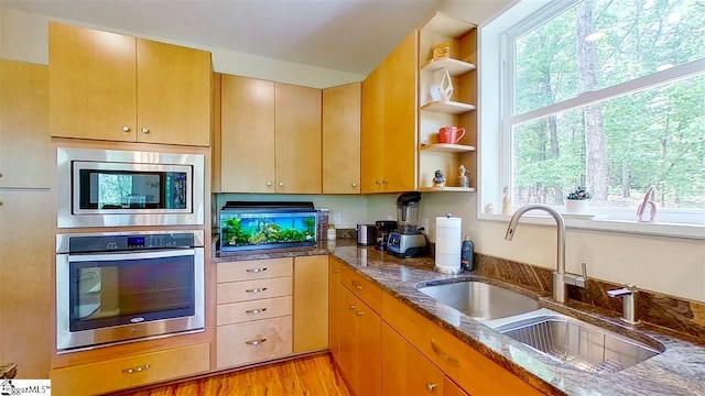 kitchen featuring light hardwood / wood-style flooring, sink, stainless steel appliances, and plenty of natural light