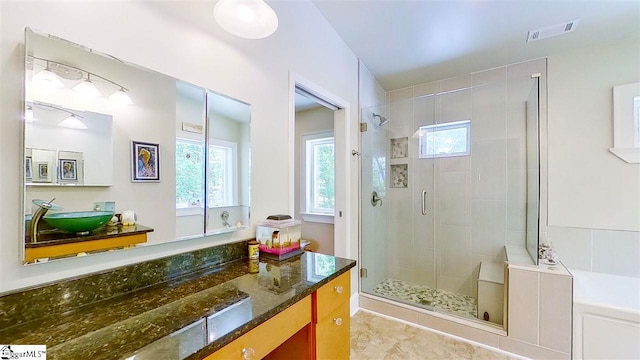 bathroom featuring tile floors, an enclosed shower, oversized vanity, and a healthy amount of sunlight