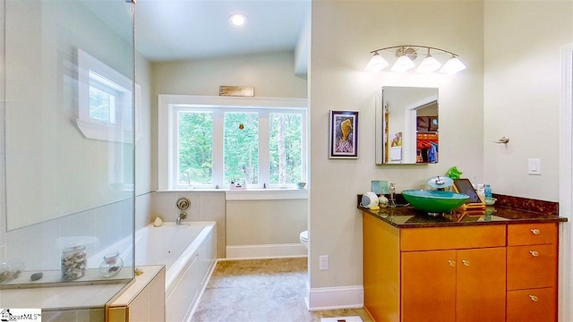 bathroom featuring tile flooring, toilet, vanity, a bath, and lofted ceiling