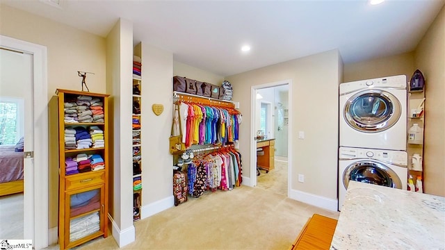 interior space with stacked washer and dryer and light carpet