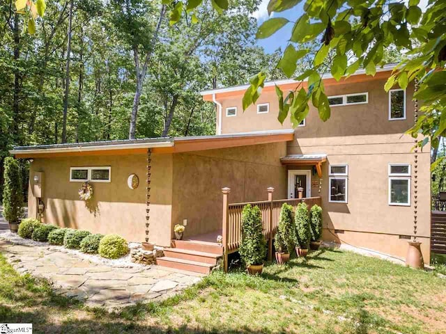 back of property featuring a wooden deck