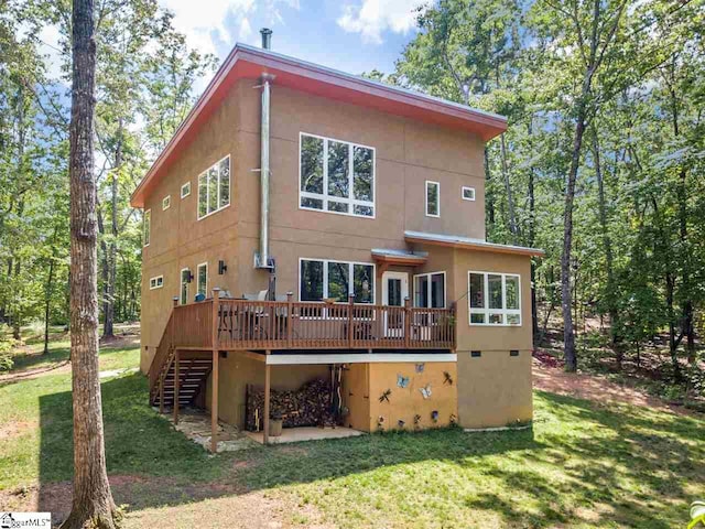 back of property featuring a deck and a yard