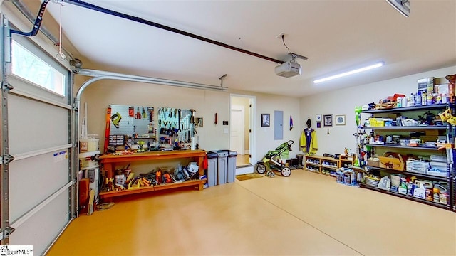 garage featuring a garage door opener and a workshop area