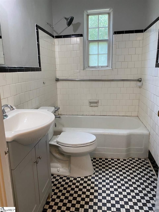 full bathroom with tile floors, oversized vanity, toilet, and tile walls