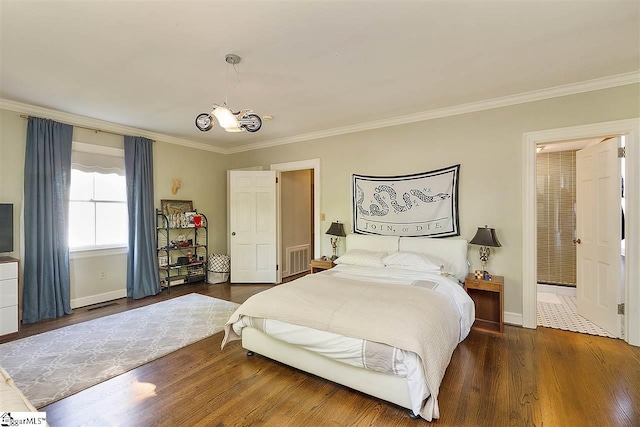 bedroom featuring ornamental molding and dark hardwood / wood-style flooring