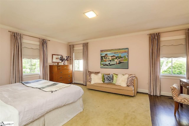 bedroom featuring ornamental molding and hardwood / wood-style floors