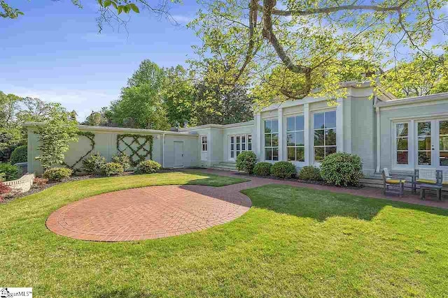 rear view of property with a yard