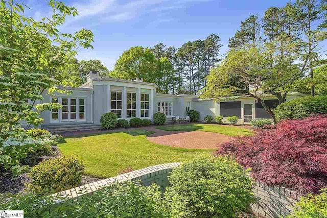 rear view of house with a lawn