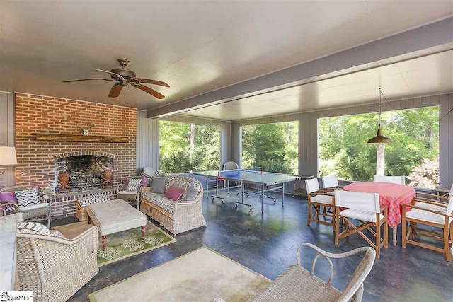 exterior space with ceiling fan and an outdoor living space with a fireplace