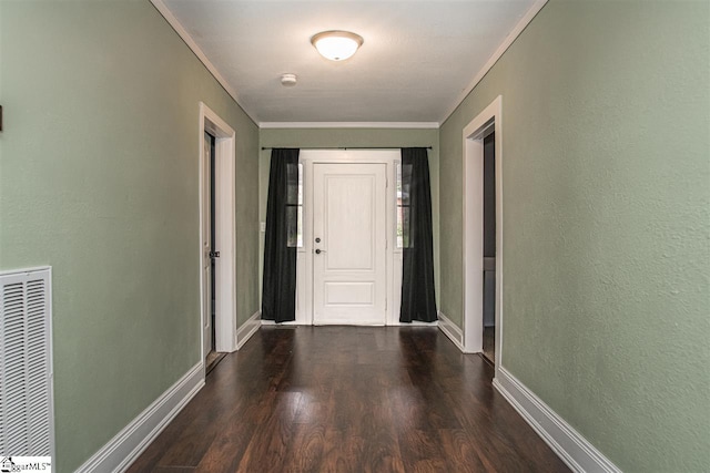 hallway with ornamental molding and dark wood-type flooring