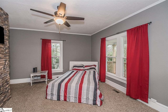 carpeted bedroom featuring ornamental molding, a textured ceiling, and ceiling fan