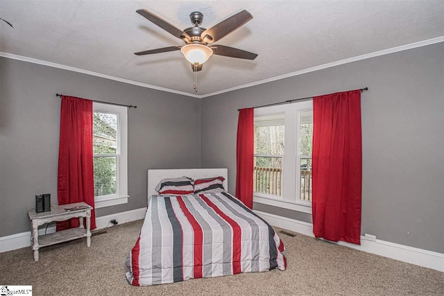 bedroom with ceiling fan, crown molding, and carpet