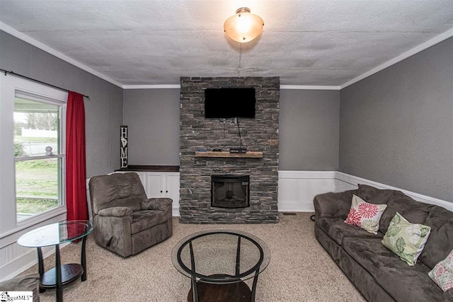 carpeted living room with ornamental molding, a textured ceiling, and a fireplace