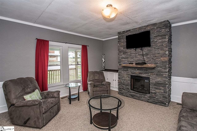 living room featuring crown molding, a stone fireplace, and light carpet